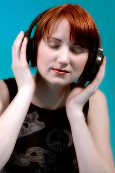 Red haired girl listening to her favourite music