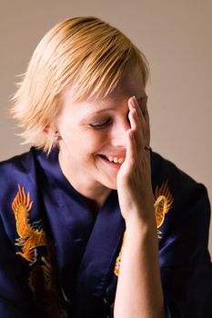 Studio portrait of a smiling happy short haired blond girl