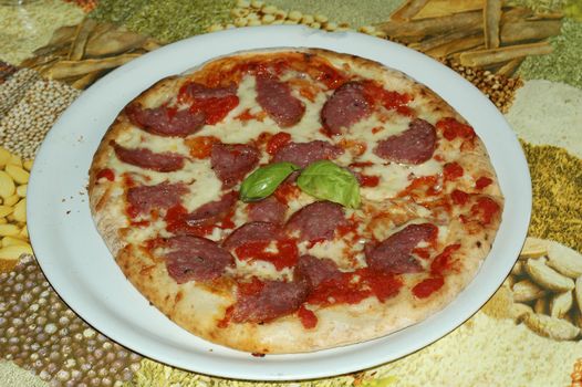 a spicy salami pizza just served in pizzeria restaurant