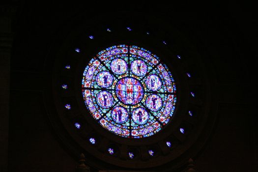 A rose window of a catholic church from the inside.
