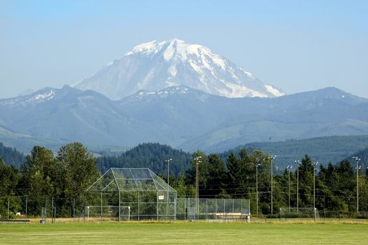 A majestic Mount Rainier towers over a soccer field in Washington State, USA.
