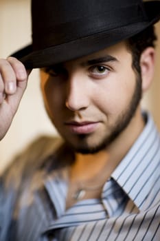 Handsome Young Man Indoors Wearing a Fedora Hat