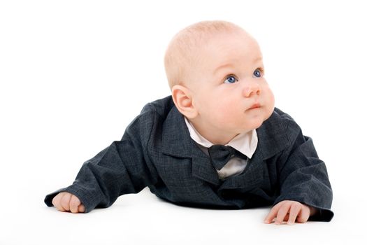 Toddler boy in a suit crawling on isolated background
