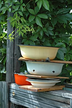 Dirty plates, bowls, knifes and plugs after picnic on a summer residence
