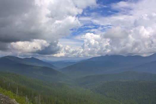 Mountains eyes of a bird. The fine sky and the infinite mountains disappearing in a blue fog. Beauty untouched the person of a nature.