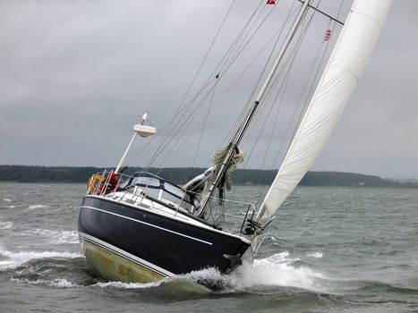 Yacht racing in a windy dark winter day
