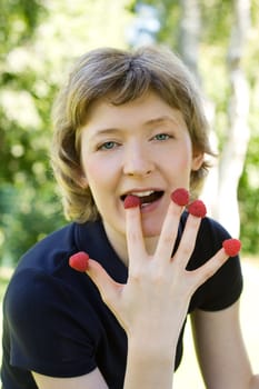 woman with raspberries, shot outdoors