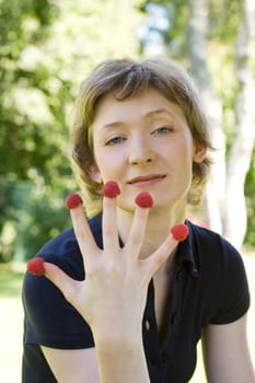 woman with raspberries, shot outdoors