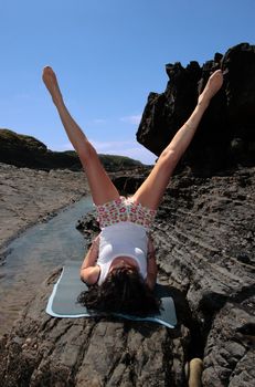 a beautiful woman doing yoga to show a healthy way to live a happy and relaxed lifestyle in a world full of stress