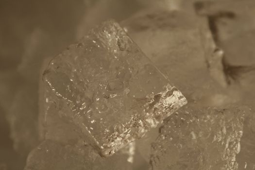 A close up of an ice cube with rough texture.