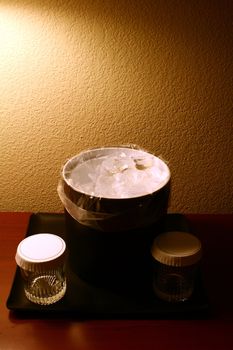 A photograph of a hotel ice bucket and glasses.