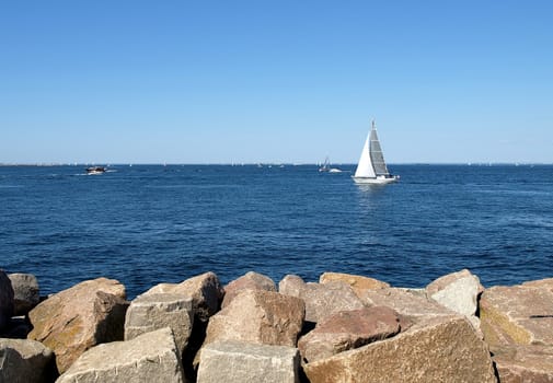 white sailboat on seen near the coast