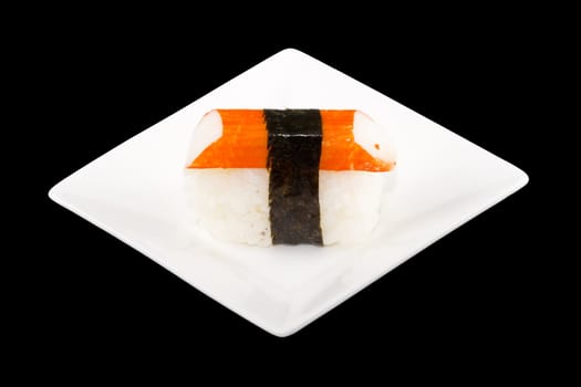 a square white plate with a piece of sushi