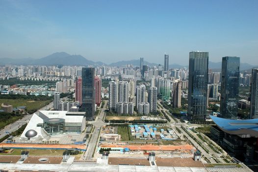 China, Guangdong province, modern, prosperous Shenzhen city. General, aerial view from high building. New office skyscrapers, shops and hotels in Futian district.
