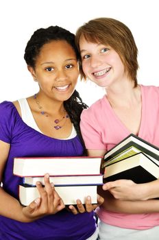 Isolated portrait of two teenage girls holding text books