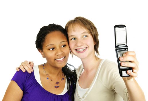 Isolated portrait of two teenage girls with camera phone