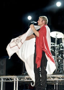Duran Duran frontman and vocalist Simon Le Bon wearing the Malta flag on stage in Malta on 26th July 2008 during Red Carpet Massacre Tour