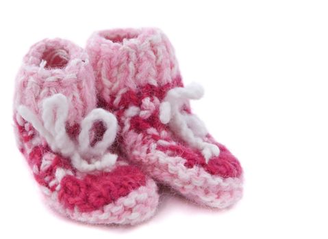 Knitted baby footwear isolated against a white background.