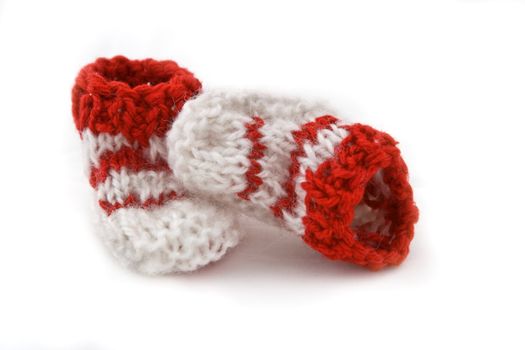 Funny knitted baby footwear isolated against a white background.