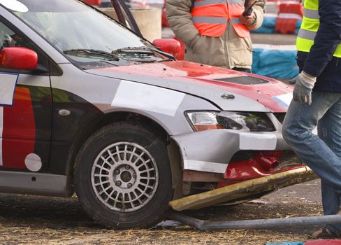 Detail of an car accident during a car race.
