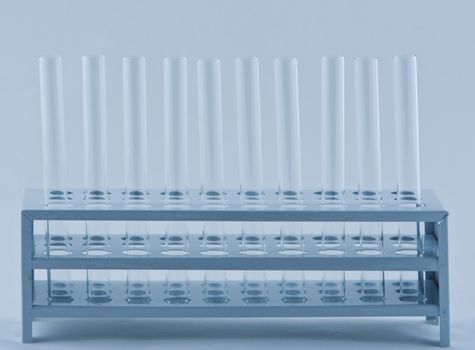 Empty laboratory tubes in a support.