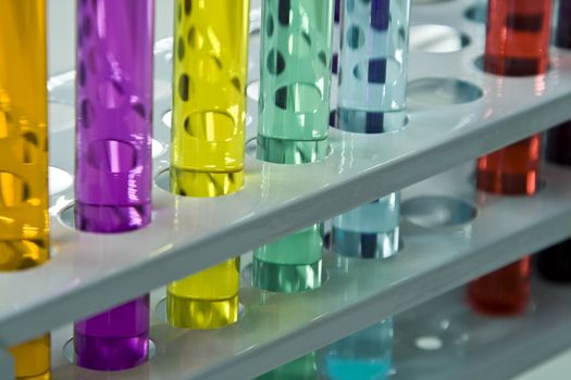 Colorful image and interesting reflections on a test tubes stand; unmodified specific lighting for a laboratory.