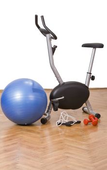 Sports gear on the floor in a gym.