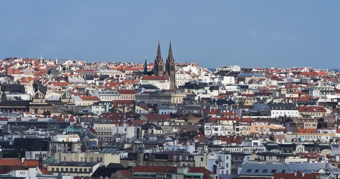 Overview of Prague featuring the Ludmila Church towers.