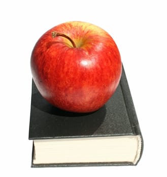 Red apple on the book.