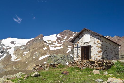 small chapel in Stelvio National park, Trentino, Italy. On the background Cevedale mountain