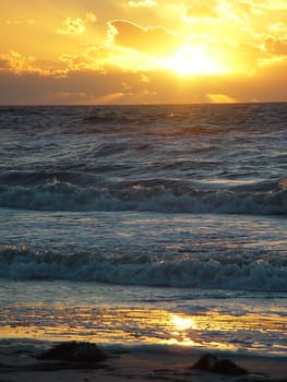 A brilliant sunset over a highly textured surface.