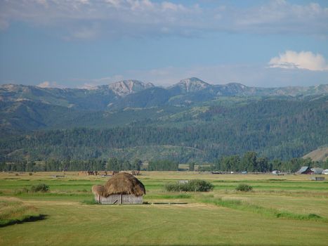 A small earthen hut in a mountain valley.