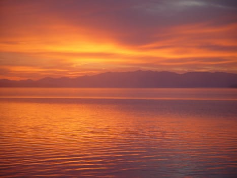 The summer sun rises in dramatic fashion over Yellowstone Lake.