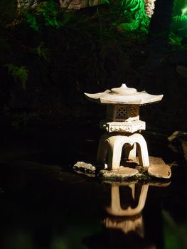 A Japanese sculpture on a pond.