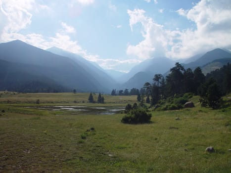 A valley floor with mountains in the background.