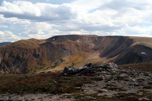 Here the summer green of the high alpine tundra has turned to its fall colors.