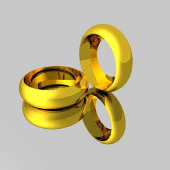 Computer model of gold wedding rings on a mirror backdrop.