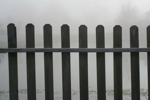 An old wooden fence with a foggy background