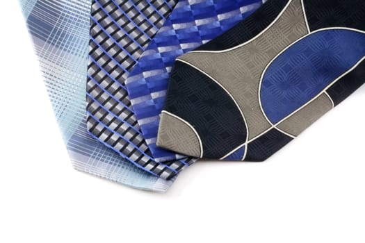 A group of four blue neck ties isolated on white.