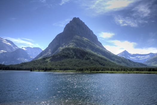 A glacier carved mountain rises above a lake.