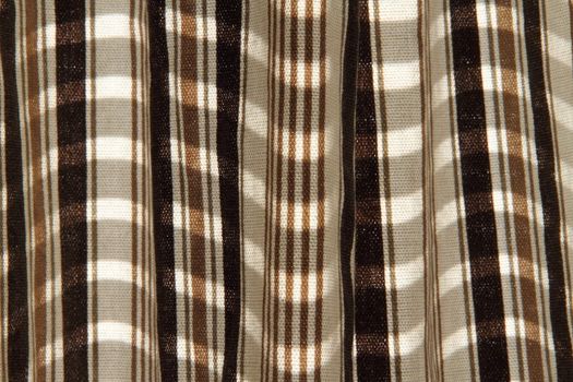 Detail of a striped fabric with sunlight