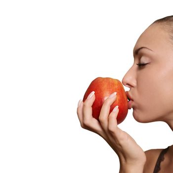 The girl kisses a red apple isolated in white