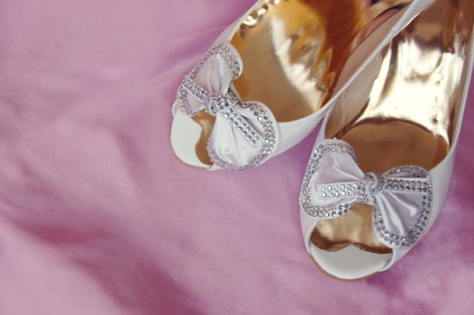 wedding bridal shoes on pink satin