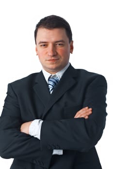 Confident young businessman standing with his arms crossed against white 