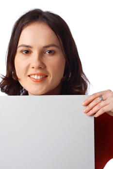 Closeup portrait of a pretty young woman holding a blank billboard on white