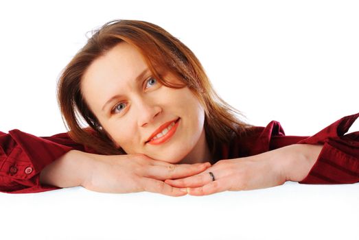 Portrait of a young attractive smiling business woman holding a big poster on one side, isolated over white background