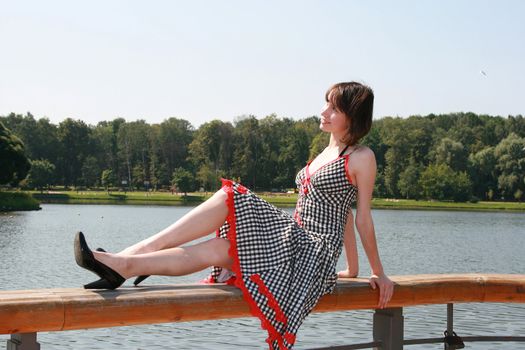 The girl sits on a bench and has a rest