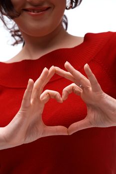 A close up picture of two hands showing a heart symbol