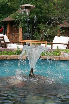 Small freshening fountain in blue pool