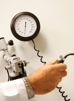 Doctor measuring blood pressure at a hospital room